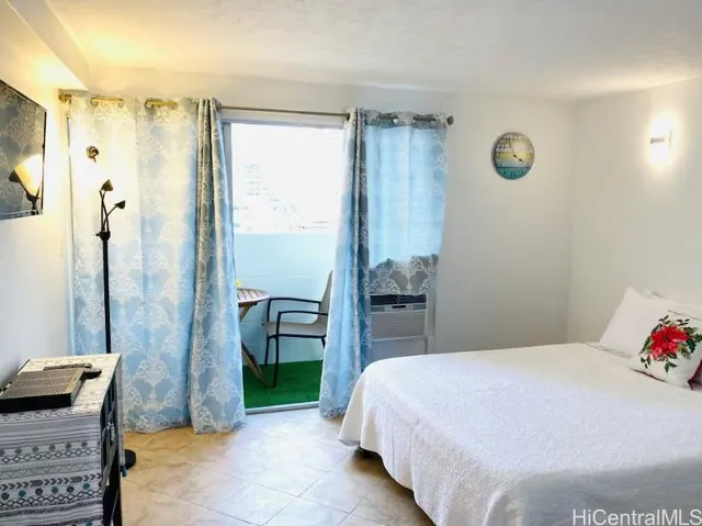 a bedroom with a bed and a shower