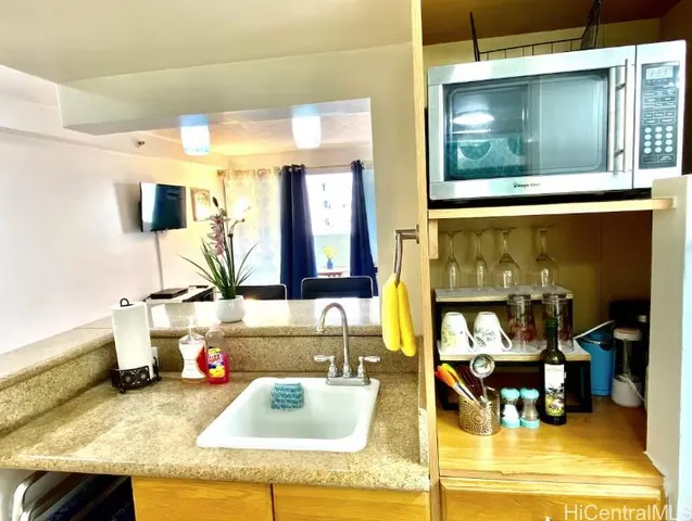 a bathroom with a granite countertop sink toilet a large mirror and a shower