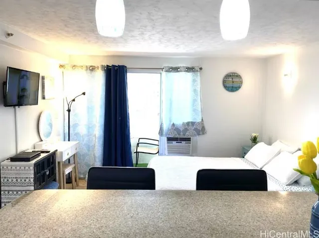 a living room with furniture a flat screen tv and a large window