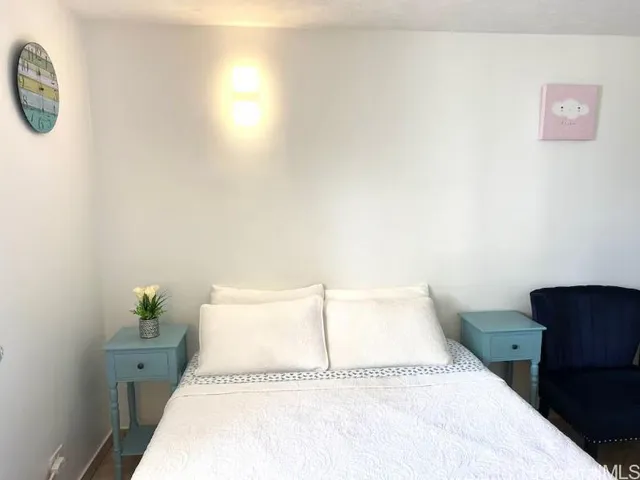 a bedroom with a bed and a lamp