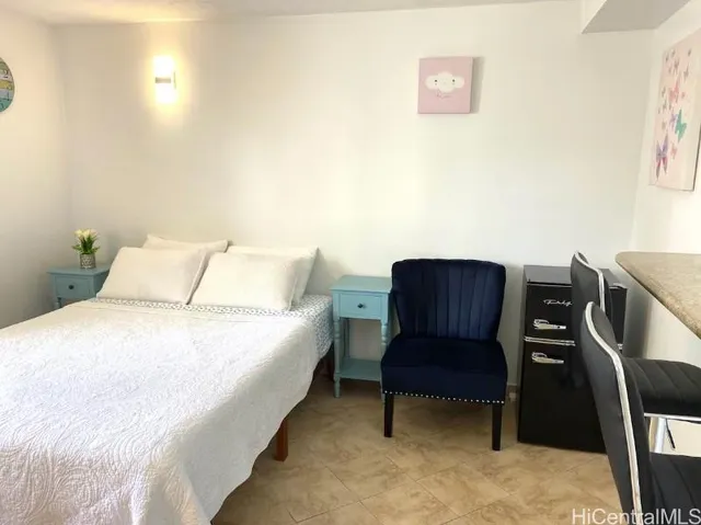 a bed room with a bed and chair