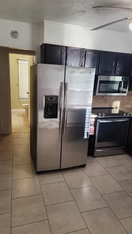 a kitchen with a stove and a refrigerator