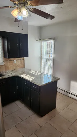 a kitchen with stainless steel appliances granite countertop a sink and a microwave