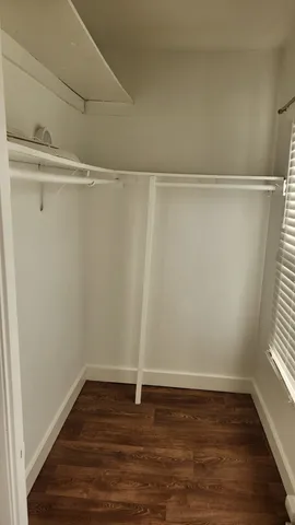 a view of a room with wooden floor