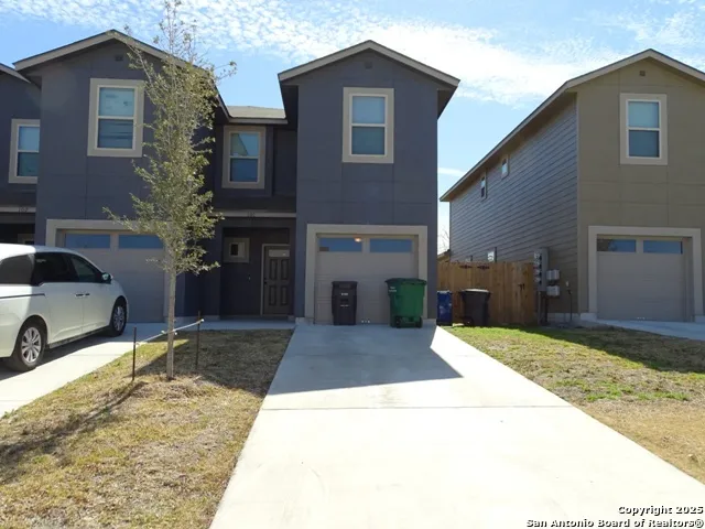 a view of a house with a yard and garage