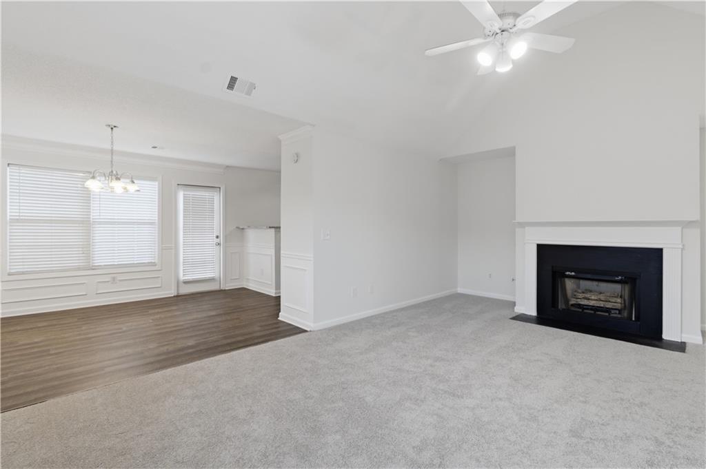 11657 Flemming Court Hampton, GA 30228 - Photo 12 of 30 an empty room with a fireplace and window