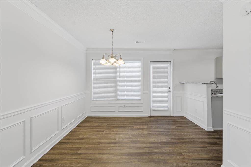 11657 Flemming Court Hampton, GA 30228 - Photo 14 of 30 a view of empty room with wooden floor