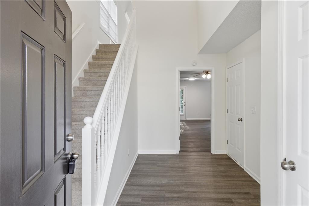 11657 Flemming Court Hampton, GA 30228 - Photo 2 of 30 a view of a hallway with wooden floor and staircase