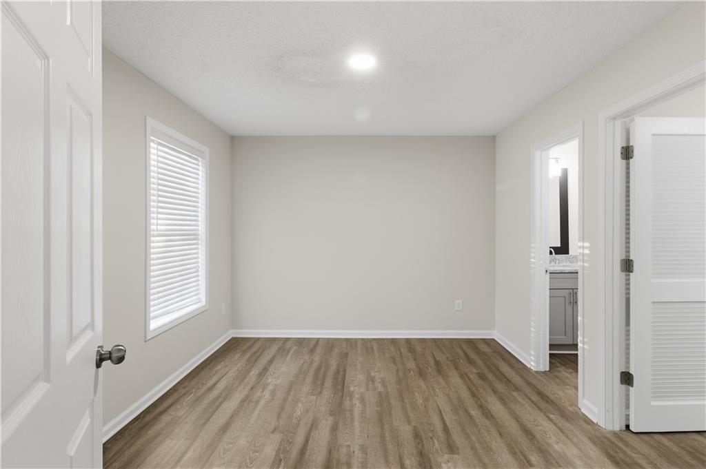 11657 Flemming Court Hampton, GA 30228 - Photo 6 of 30 an empty room with wooden floor and windows