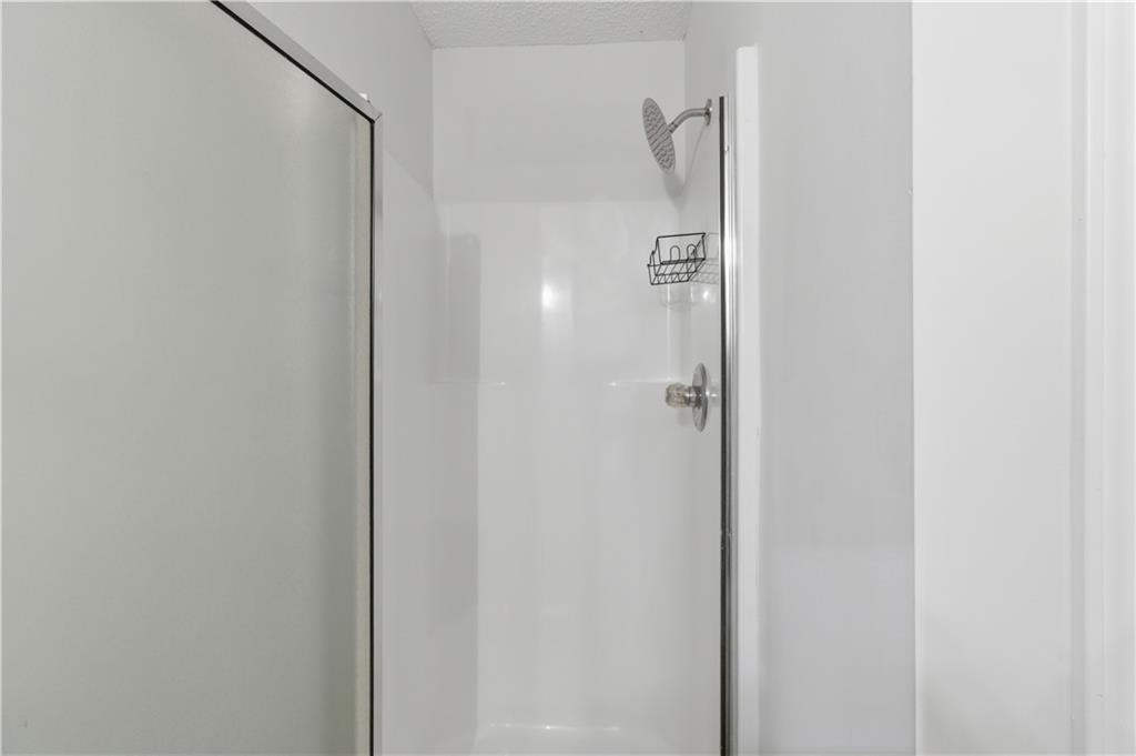 11657 Flemming Court Hampton, GA 30228 - Photo 9 of 30 a bathroom with a shower and a glass door
