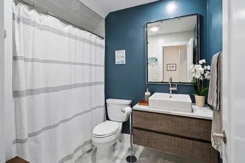 a bathroom with a sink toilet and mirror