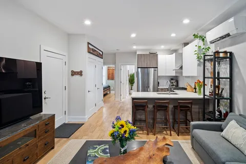 a kitchen with stainless steel appliances granite countertop a refrigerator and a stove top oven