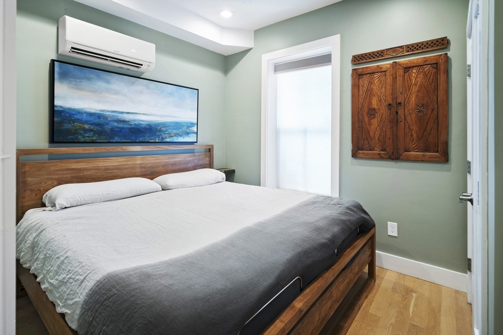 55 East Springfield Street, Unit 2 Boston, MA 02118 - Photo 9 of 22 a bedroom with a bed and wall painting