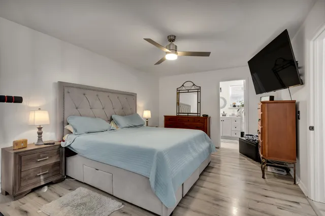 a bedroom with a bed and a flat screen tv