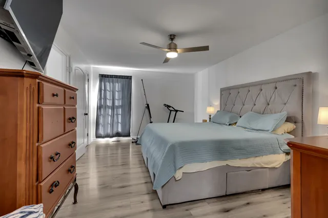 a bedroom with bed and a chandelier
