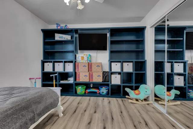 a living room with furniture and a book shelf