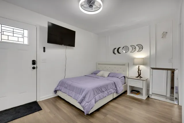 a bedroom with a bed and a flat screen tv
