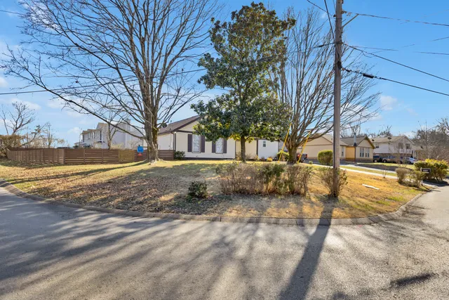 a view of yard covered with snow in front of house