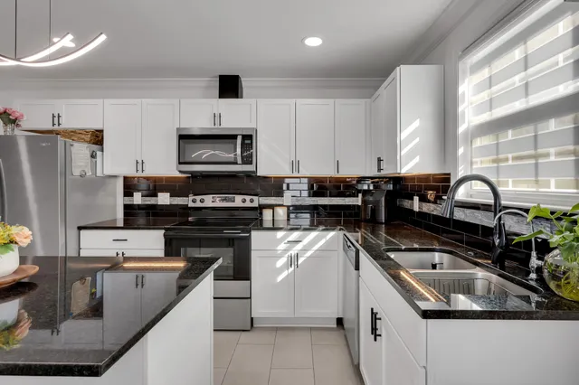 a kitchen with a sink stove and refrigerator
