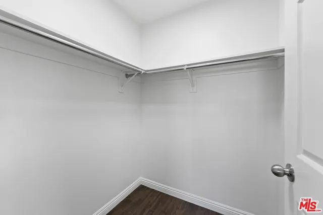 an entryway and a hallway with wooden floor