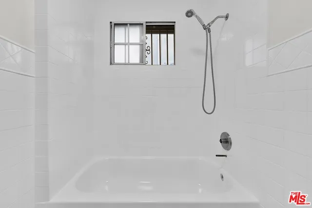 a kitchen with granite countertop white cabinets and sink