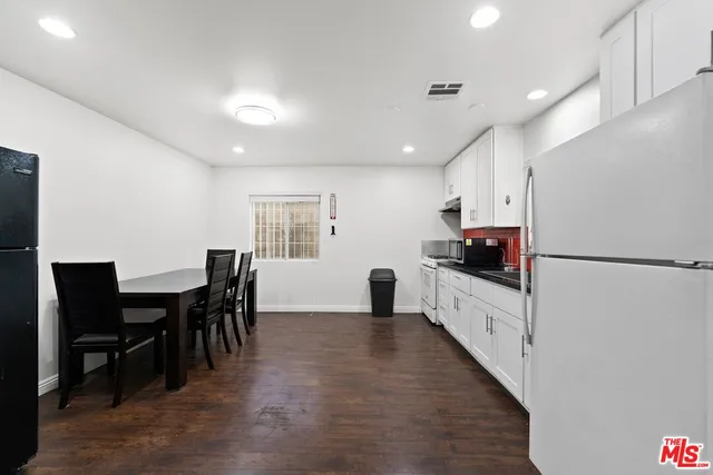 a bathroom with a shower sink vanity mirror and toilet