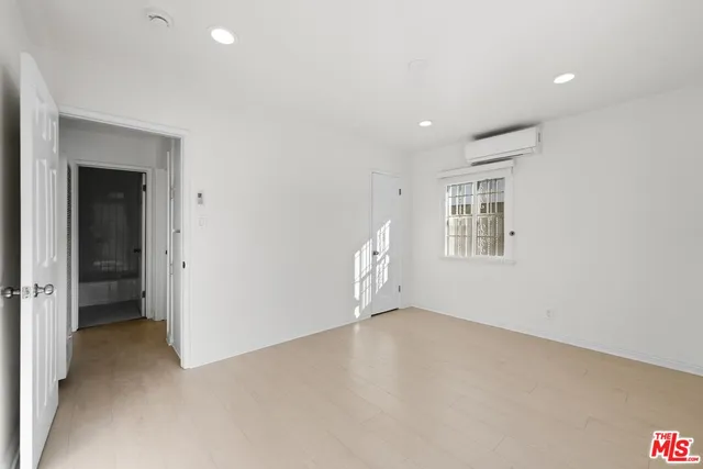 a view of a room with wooden floor lounge chair and windows