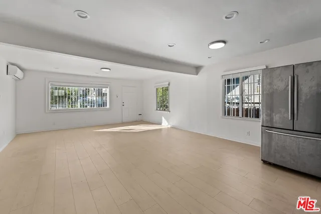 a view of a room with wooden floor and white walls
