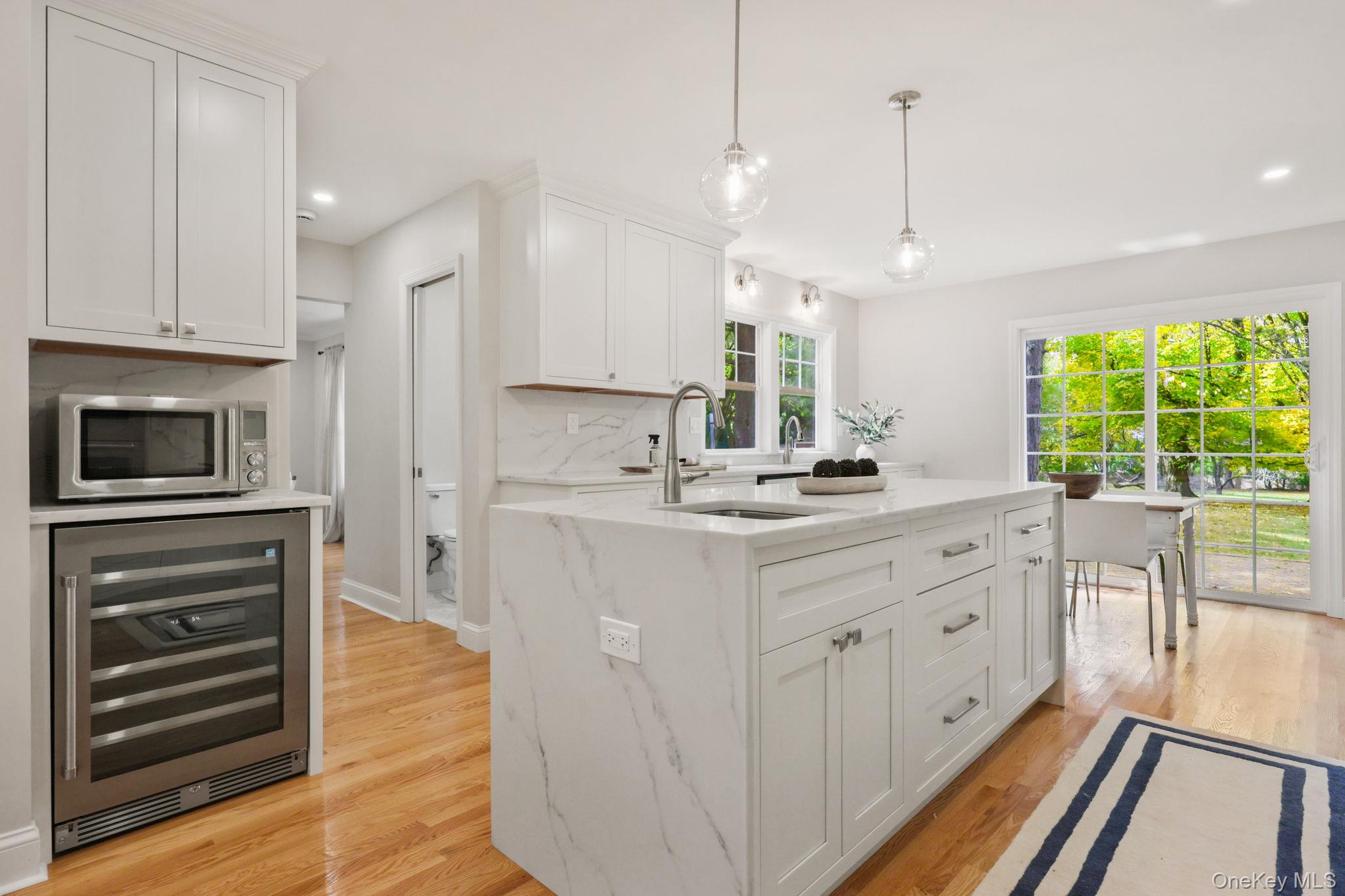 790 Hardscrabble Road Chappaqua, NY 10514 - Photo 15 of 43 a kitchen with kitchen island granite countertop a stove a sink a center island and a window
