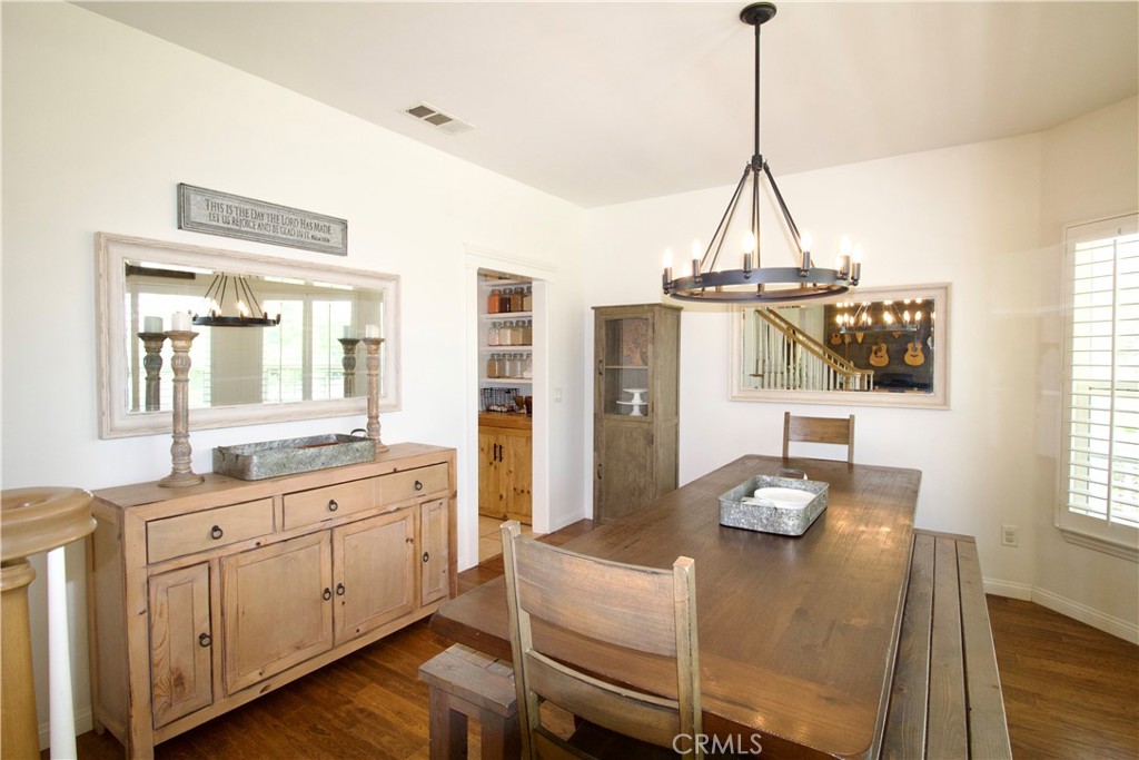 35159 El Dorado Road Lake Elsinore, CA 92530 - Photo 16 of 72 a view of a dining room with furniture and wooden floor