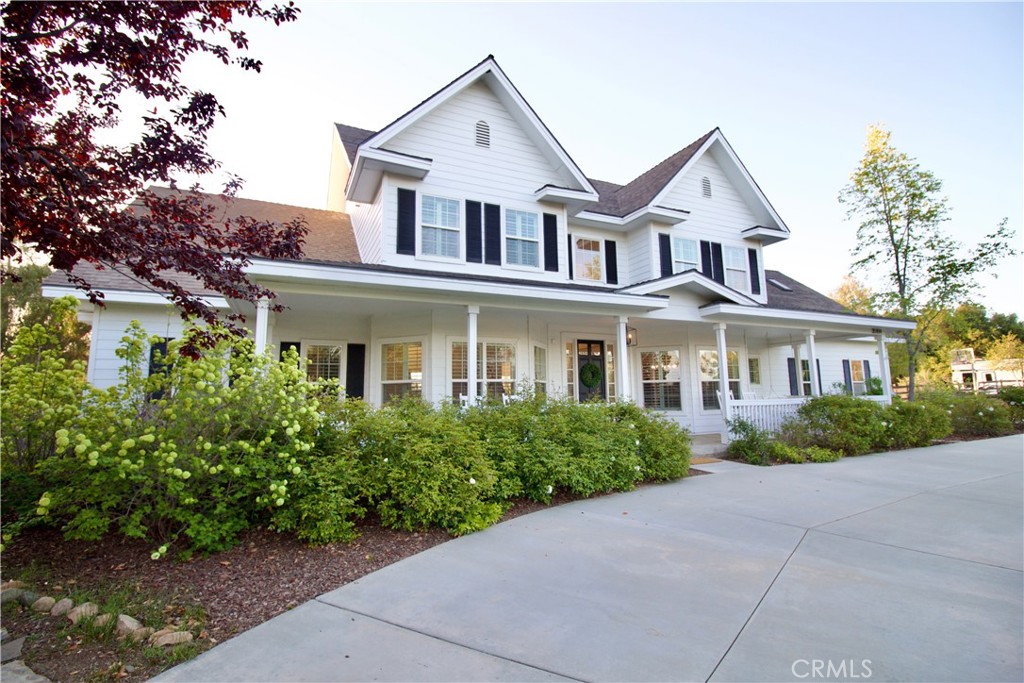 35159 El Dorado Road Lake Elsinore, CA 92530 - Photo 3 of 72 a front view of a house with a yard and trees
