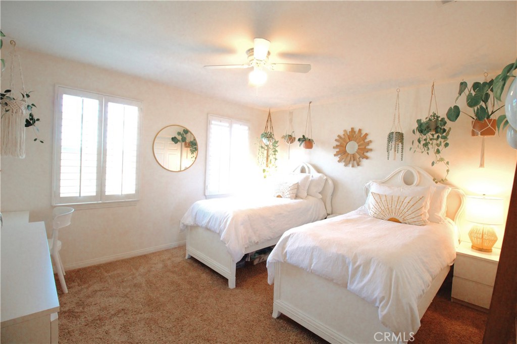 35159 El Dorado Road Lake Elsinore, CA 92530 - Photo 33 of 72 a bedroom with two beds and a chandelier