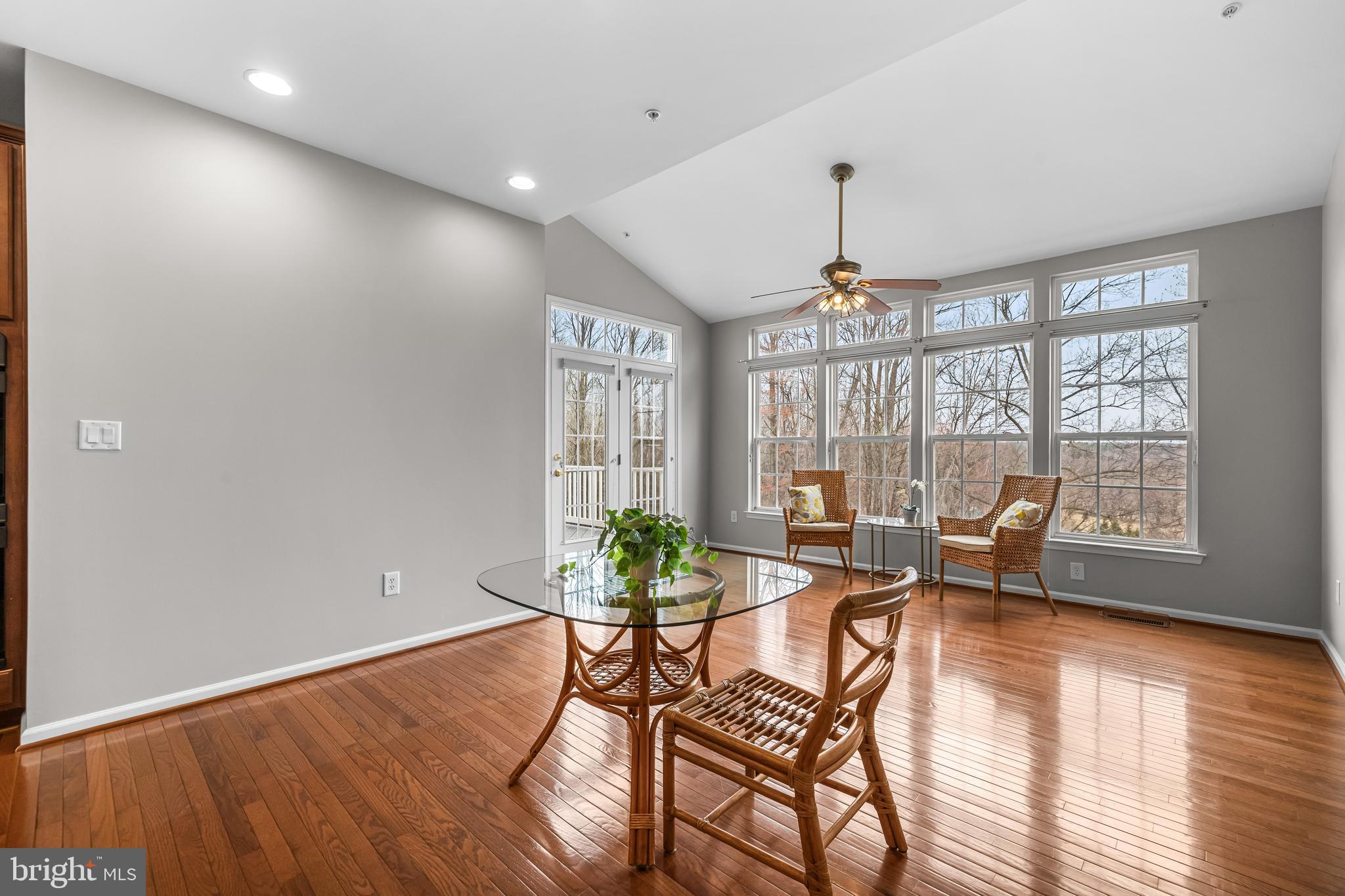 8330 Meadowsweet Road, Unit 8330 Pikesville, MD 21208 - Photo 13 of 55 a living room with furniture and floor to ceiling windows