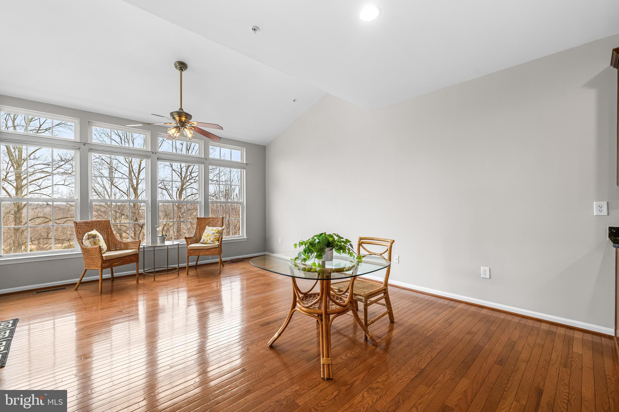 8330 Meadowsweet Road, Unit 8330 Pikesville, MD 21208 - Photo 14 of 55 a view of a livingroom with furniture wooden floor and a floor to ceiling window