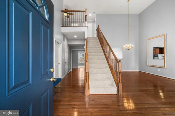 a view of entryway and hall with wooden floor