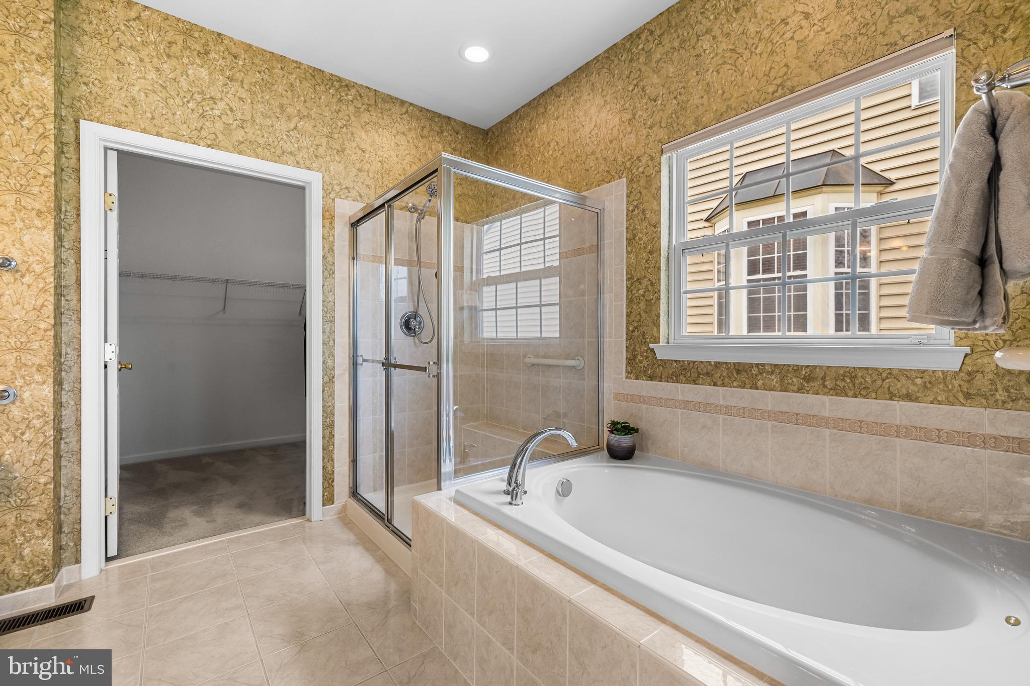 8330 Meadowsweet Road, Unit 8330 Pikesville, MD 21208 - Photo 29 of 55 a bathroom with a bathtub and a shower