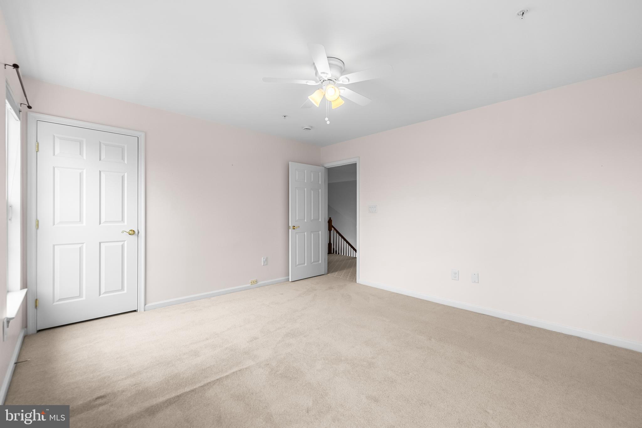 8330 Meadowsweet Road, Unit 8330 Pikesville, MD 21208 - Photo 38 of 55 a view of an empty room with a ceiling fan