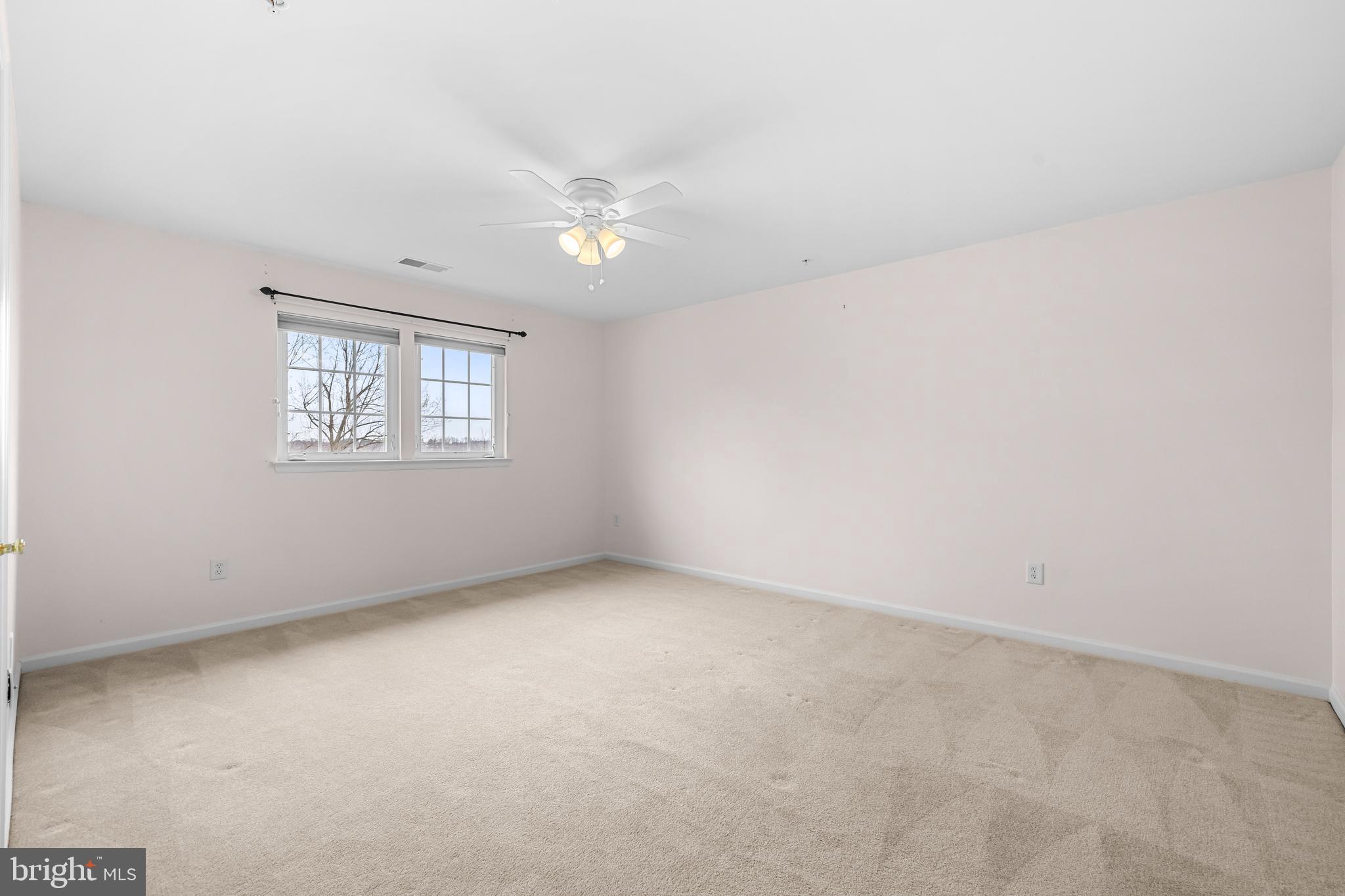 8330 Meadowsweet Road, Unit 8330 Pikesville, MD 21208 - Photo 40 of 55 an empty room with a empty space and windows