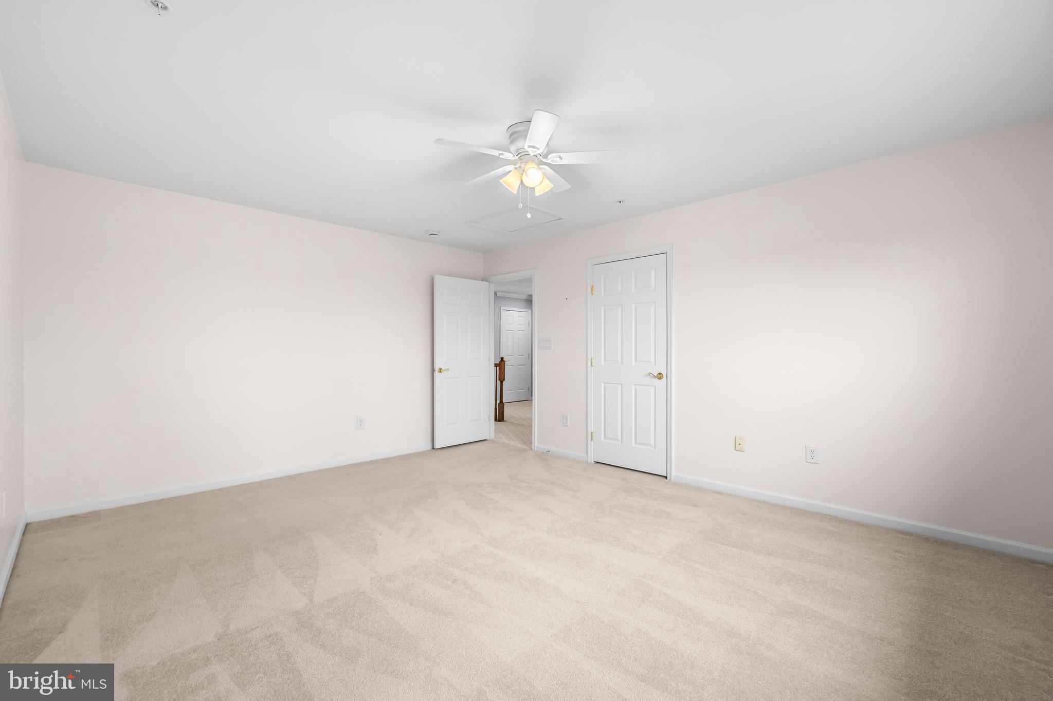 8330 Meadowsweet Road, Unit 8330 Pikesville, MD 21208 - Photo 41 of 55 an empty room with a ceiling fan and a window