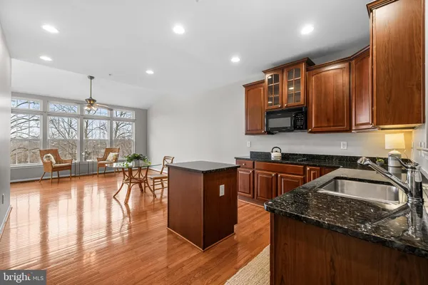 a kitchen with wooden cabinets sink and stove