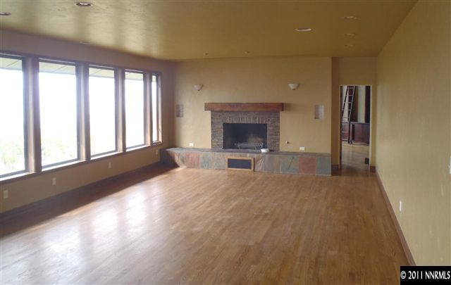 1895 West Huffaker Lane Reno, NV 89511 - Photo 8 of 13 a living room with a large window and a fireplace