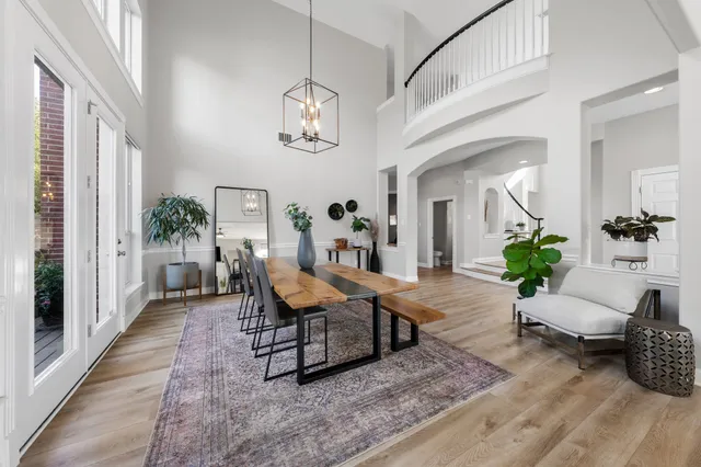 a living room with furniture wooden floor and a chandelier