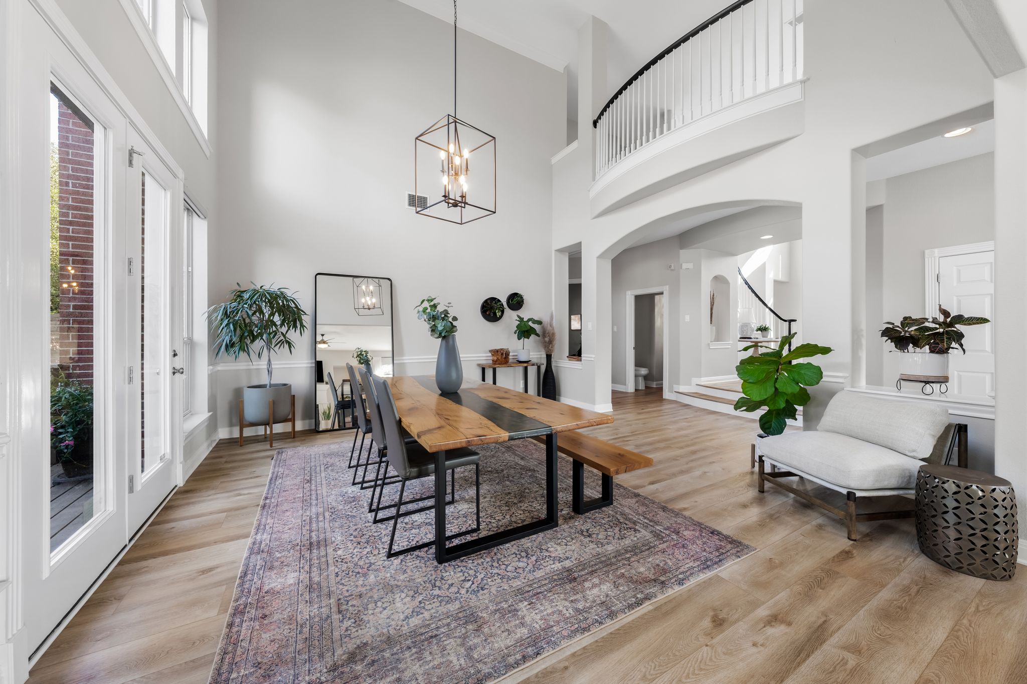 13612 Flat Top Ranch Road Austin, TX 78732 - Photo 11 of 40 a living room with furniture wooden floor and a chandelier
