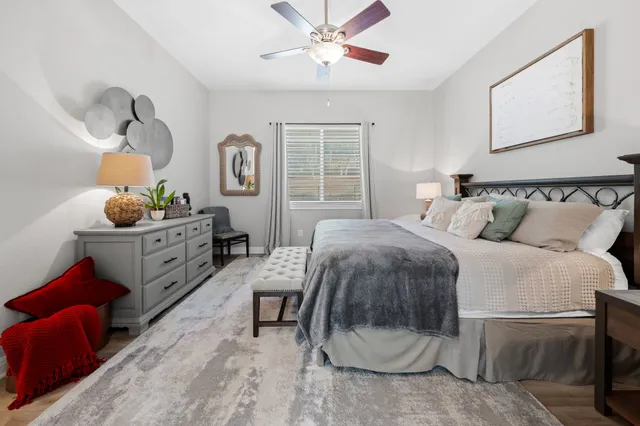 a bedroom with a bed and a chandelier