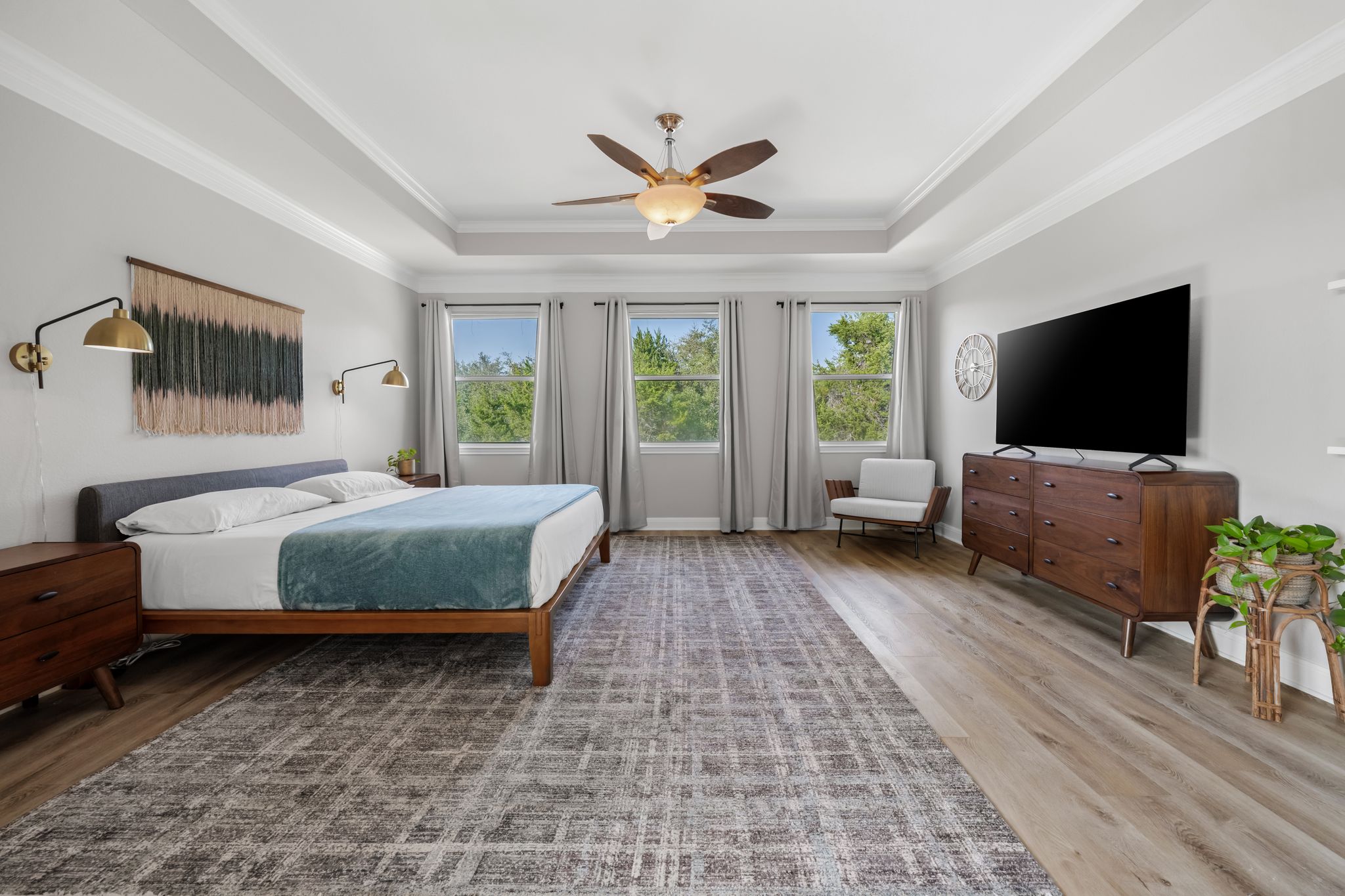 13612 Flat Top Ranch Road Austin, TX 78732 - Photo 18 of 40 a bedroom with a bed and a flat screen tv