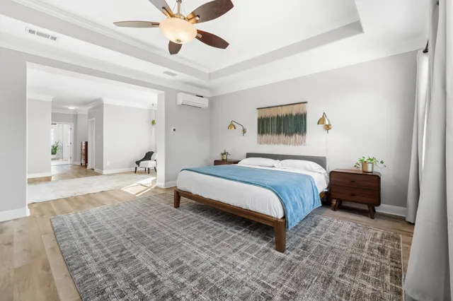 a bedroom with a bed and a chandelier