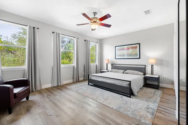 a spacious bedroom with a large bed and a window