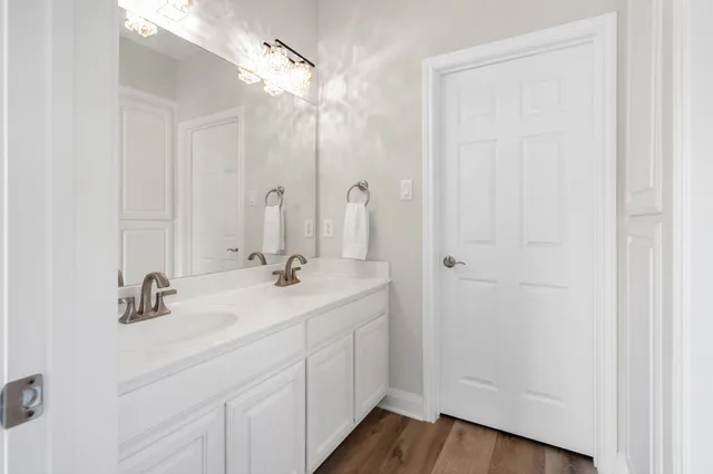 a bathroom with 2 sink and a mirror