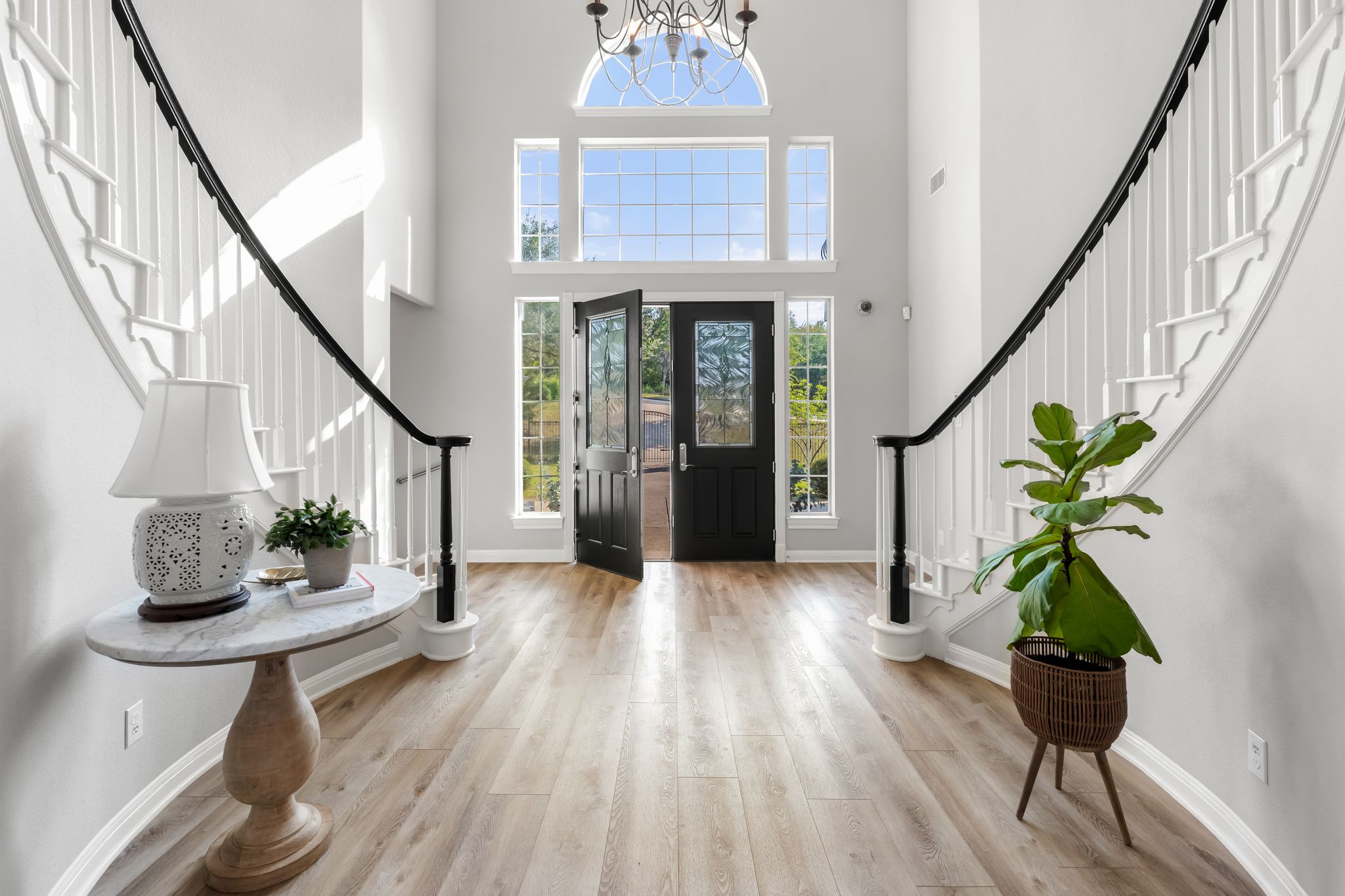 13612 Flat Top Ranch Road Austin, TX 78732 - Photo 26 of 40 a view of an entryway with wooden floor and a potted plant