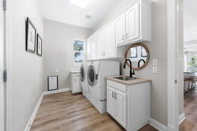 a kitchen with stainless steel appliances granite countertop a sink and a stove next to a window